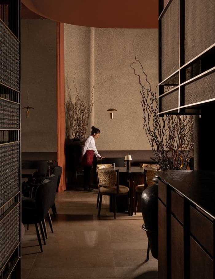 Front of house professional setting a table at an elegant restaurant in London